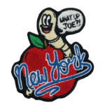 Custom New York chenille patch featuring a textured red apple, smiling worm, raised blue script lettering, and premium towel embroidery with a cut-to-shape border