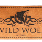 Custom engraved leather patch featuring the Wild Wolf logo with laser-etched artwork, premium tan faux leather, stitched border, and rectangular design for hats, jackets, and bags