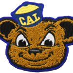 Custom chenille bear mascot patch featuring a smiling bear wearing a CAL cap with premium textured towel embroidery and vibrant varsity-style detailing