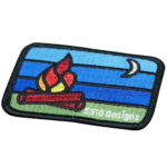 Custom embroidered camping patch with campfire and outdoor landscape design crafted with premium stitching in Ireland