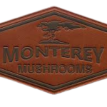Custom hexagon leather patch featuring the Monterey Mushrooms logo with embossed branding, premium brown faux leather, engraved details, and a stitched-style border for hats, jackets, and workwear